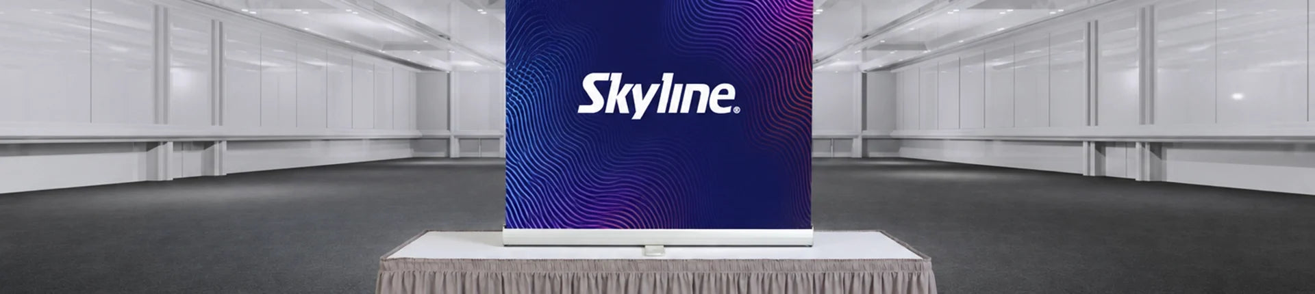 Skyline branded tabletop display with custom graphics on a trade show table