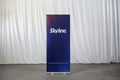 Entry-level retractable banner stand with spring-loaded aluminum base